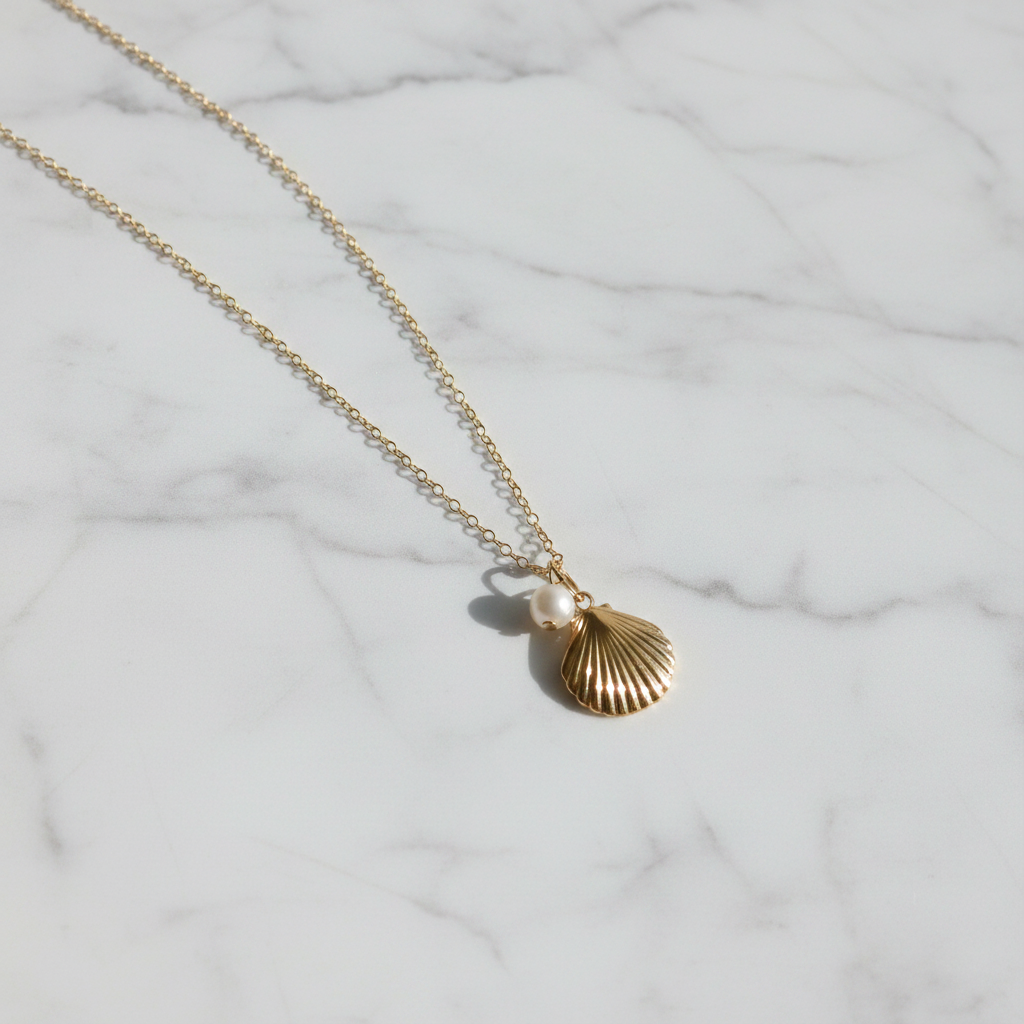 Gold Shell Necklace on White Marble